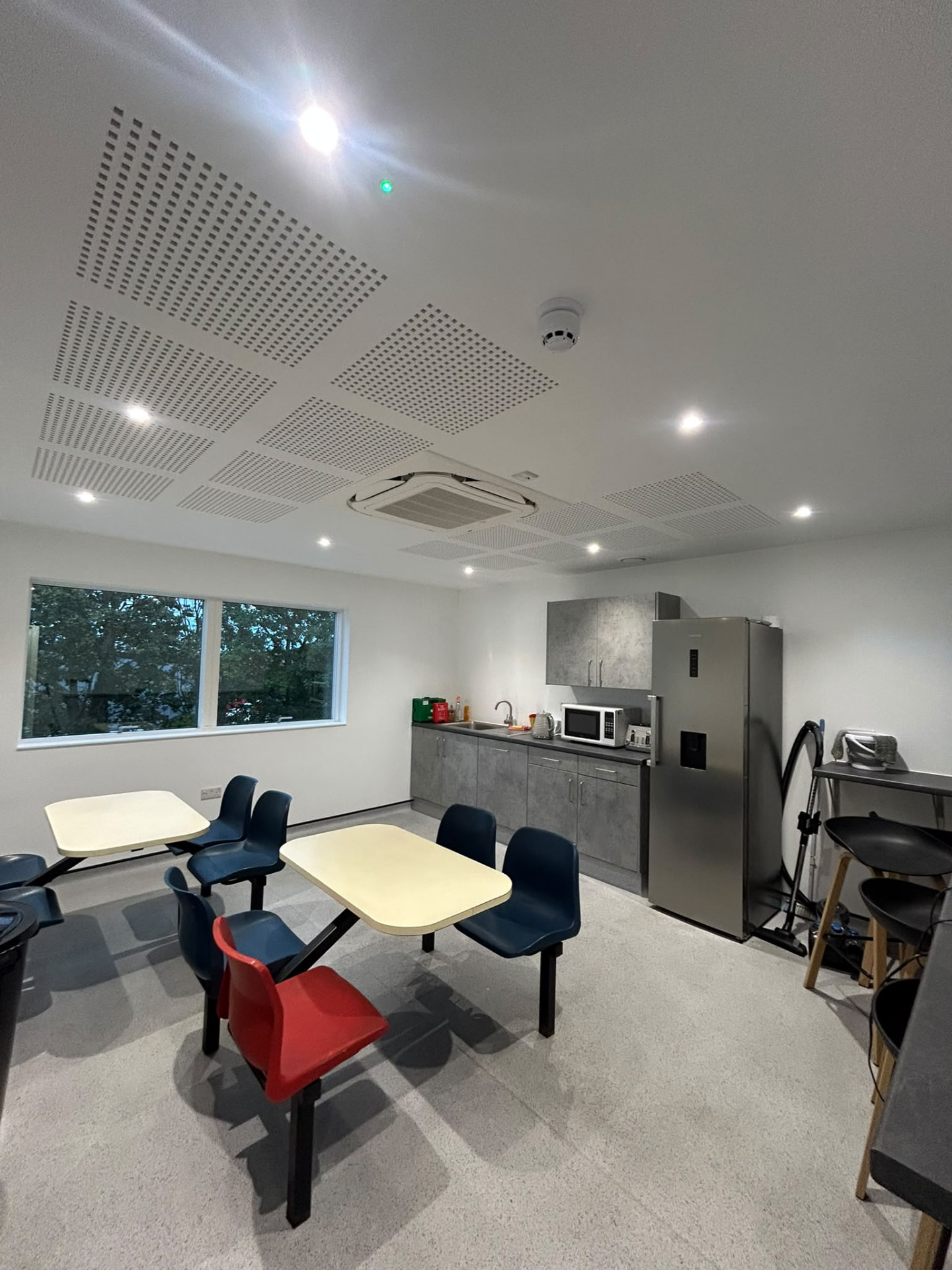 Staff breakout room with recessed lighting and emergency lighting indicator