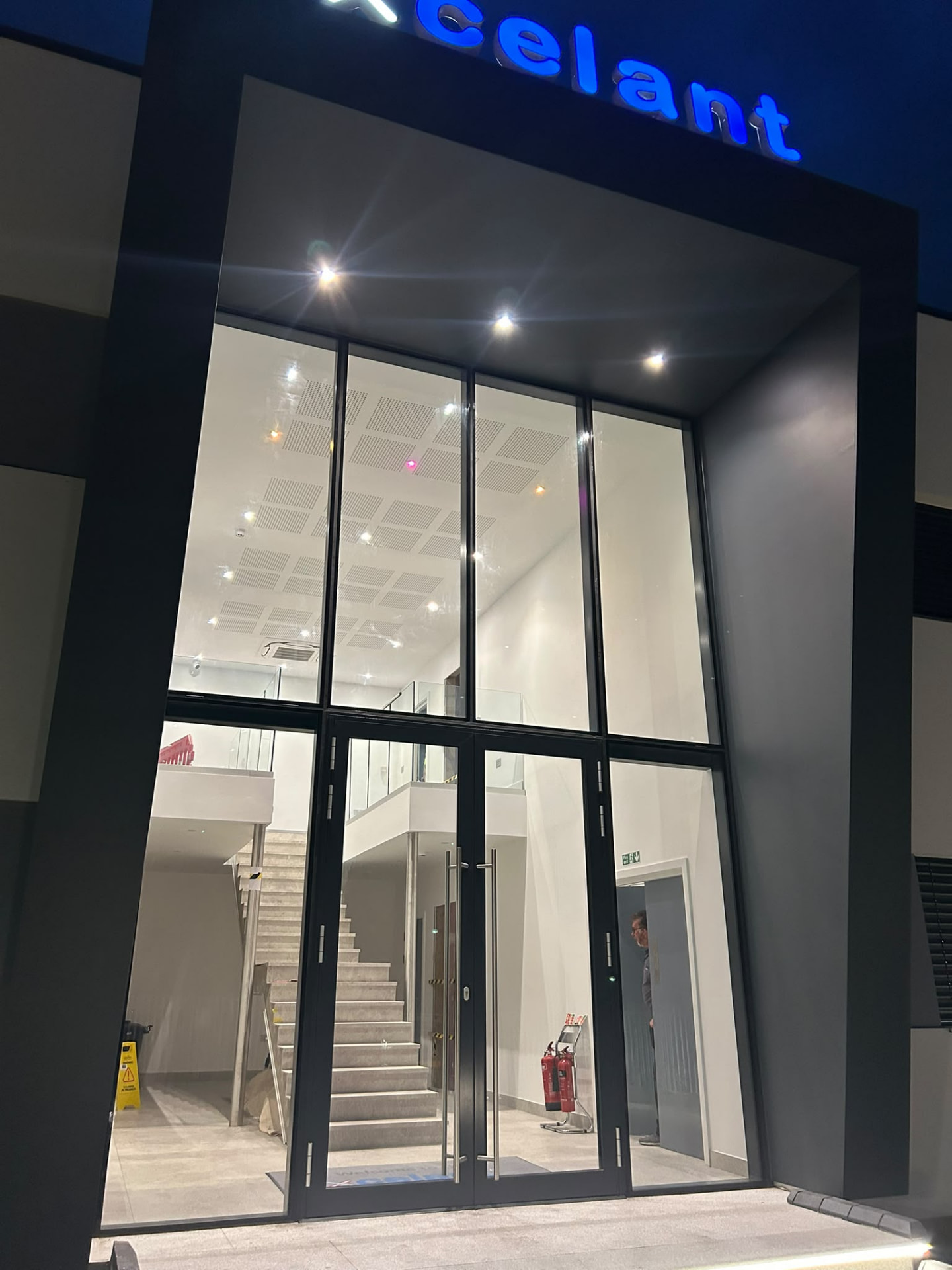 Glazed commercial entrance in Kent illuminated at night
